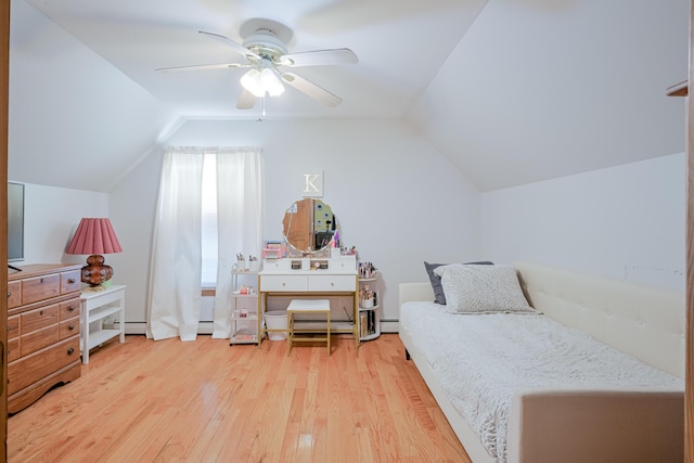 bedroom with a baseboard heating unit, ceiling fan, vaulted ceiling, wood finished floors, and a baseboard radiator