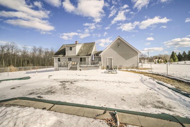 rear view of property featuring a fenced backyard, a chimney, and a wooden deck