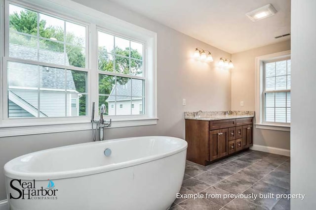 11 Clam Ln Unit A, Wells, ME 04090 - bathroom with vanity, baseboards, and a soaking tub