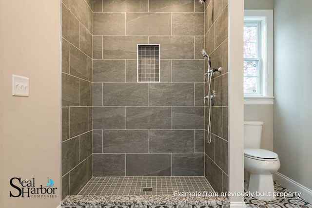 11 Clam Ln Unit A, Wells, ME 04090 - bathroom featuring a tile shower, toilet, and baseboards