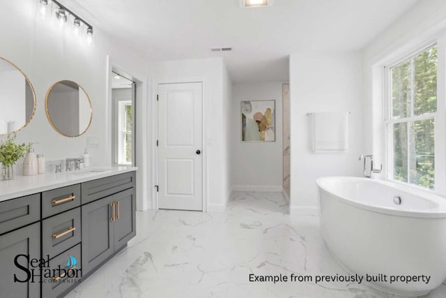 11 Clam Ln Unit A, Wells, ME 04090 - bathroom featuring baseboards, a soaking tub, vanity, and marble finish flooring