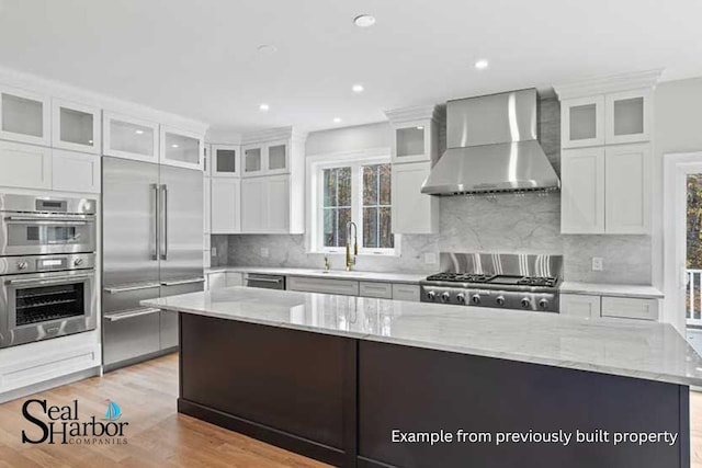 11 Clam Ln Unit A, Wells, ME 04090 - kitchen featuring wall chimney exhaust hood, appliances with stainless steel finishes, a large island, plenty of natural light, and recessed lighting