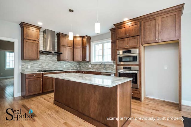 11 Clam Ln Unit A, Wells, ME 04090 - kitchen featuring wall chimney range hood, light wood-type flooring, tasteful backsplash, light stone countertops, and recessed lighting