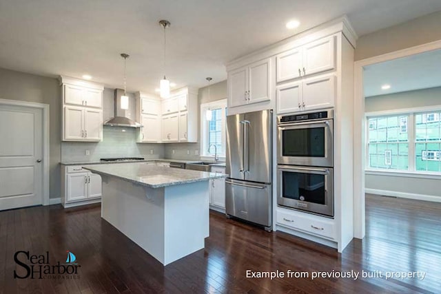 11 Clam Ln Unit A, Wells, ME 04090 - kitchen with appliances with stainless steel finishes, wall chimney exhaust hood, white cabinets, dark wood finished floors, and recessed lighting