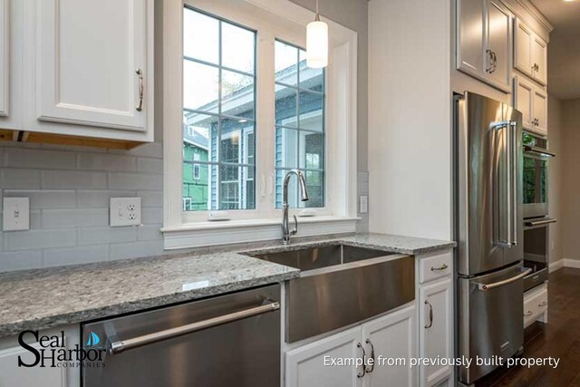 11 Clam Ln Unit A, Wells, ME 04090 - kitchen featuring stainless steel appliances, tasteful backsplash, dark wood finished floors, a sink, and light stone countertops