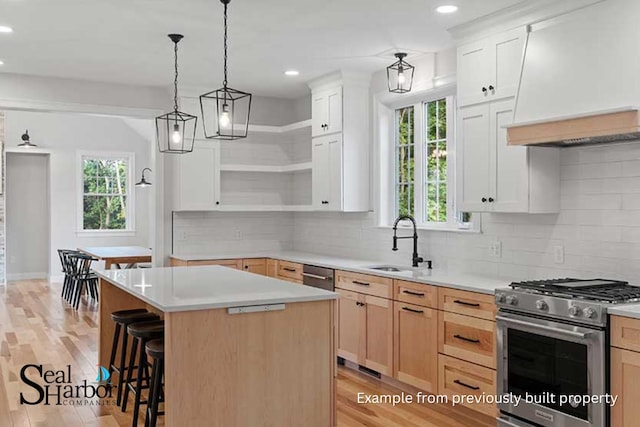 11 Clam Ln Unit A, Wells, ME 04090 - kitchen featuring appliances with stainless steel finishes, a sink, open shelves, premium range hood, and light countertops