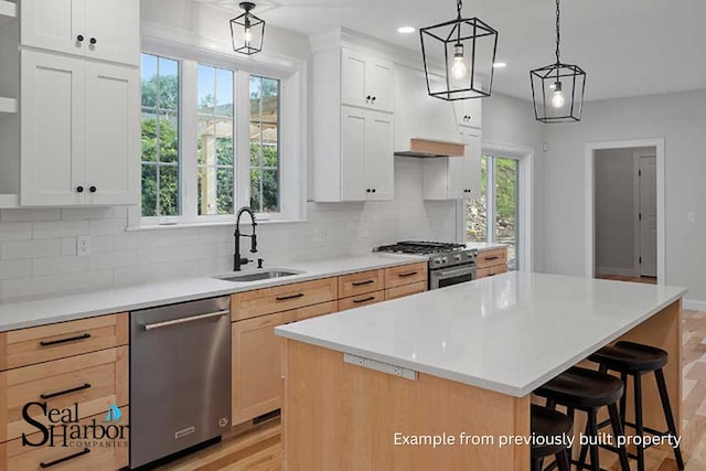11 Clam Ln Unit A, Wells, ME 04090 - kitchen with appliances with stainless steel finishes, a sink, a breakfast bar area, decorative backsplash, and recessed lighting