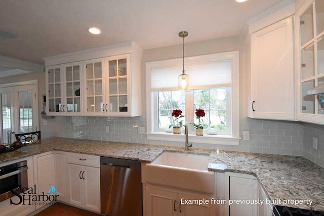 11 Clam Ln Unit A, Wells, ME 04090 - kitchen with dishwasher, a sink, white cabinets, oven, and decorative backsplash
