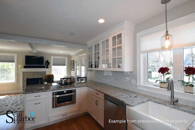 11 Clam Ln Unit A, Wells, ME 04090 - kitchen with stainless steel appliances, a sink, a peninsula, glass insert cabinets, and light stone countertops