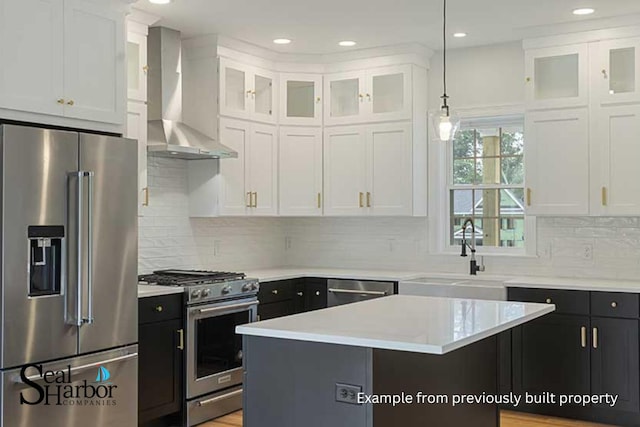 11 Clam Ln Unit A, Wells, ME 04090 - kitchen with stainless steel appliances, wall chimney exhaust hood, a sink, white cabinets, and recessed lighting