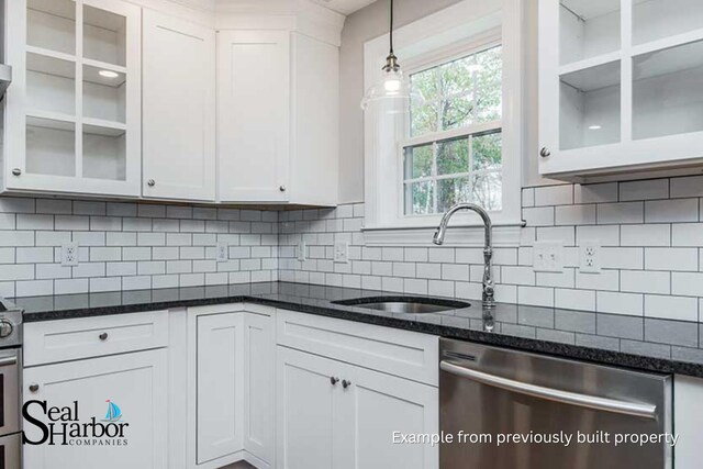 11 Clam Ln Unit A, Wells, ME 04090 - kitchen featuring stainless steel dishwasher, a sink, white cabinetry, decorative light fixtures, and dark stone counters