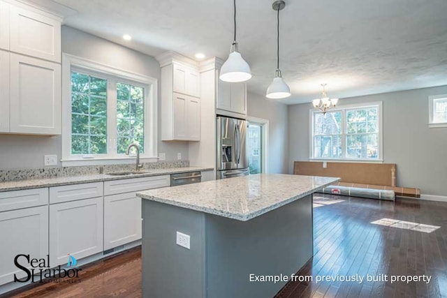 11 Clam Ln Unit A, Wells, ME 04090 - kitchen featuring appliances with stainless steel finishes, a sink, a chandelier, white cabinets, and dark wood-style floors