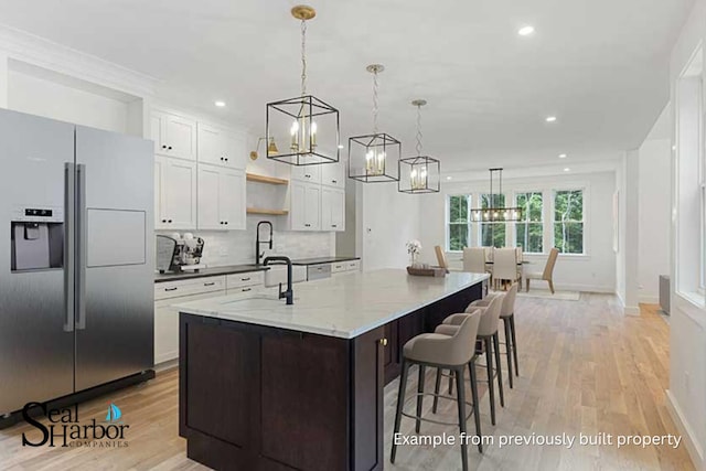 11 Clam Ln Unit A, Wells, ME 04090 - kitchen featuring stainless steel refrigerator with ice dispenser, a chandelier, light wood-style floors, a large island, and recessed lighting