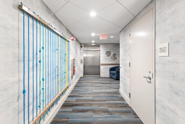 corridor with recessed lighting, a drop ceiling, elevator, and wood finished floors