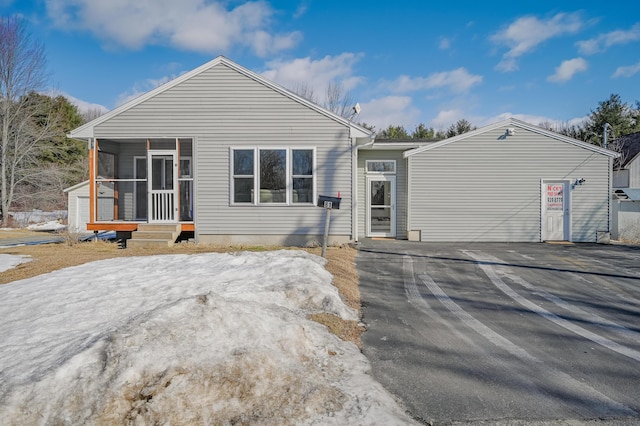 back of property with a sunroom