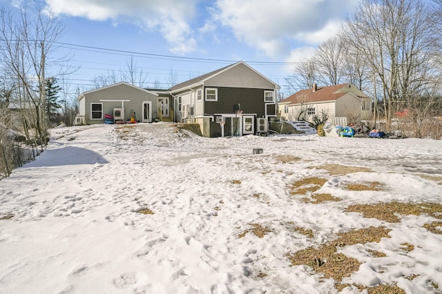 view of snow covered back of property