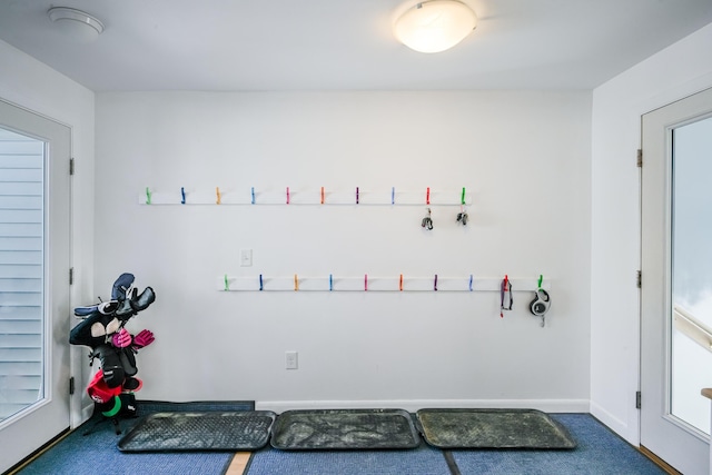 exercise room featuring carpet flooring and baseboards