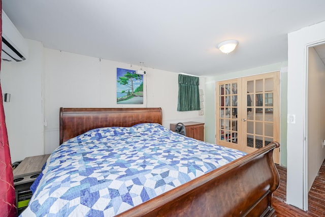 bedroom featuring french doors and wood finished floors