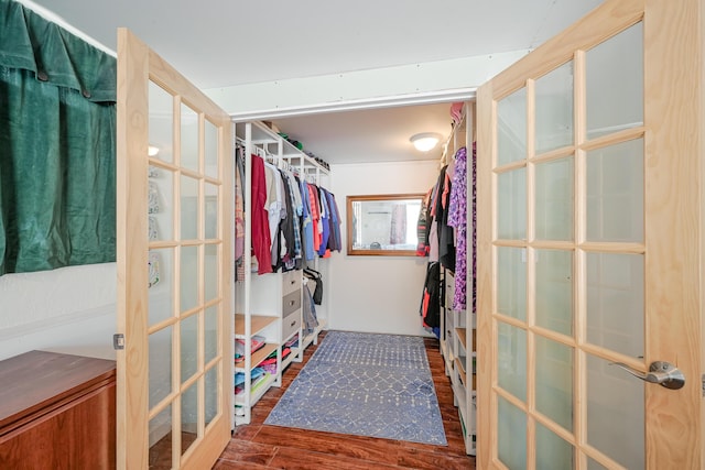 spacious closet featuring french doors and wood finished floors