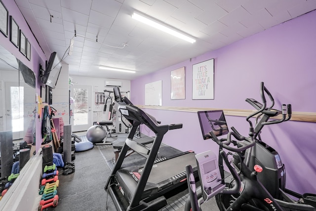 workout area featuring a wall mounted air conditioner