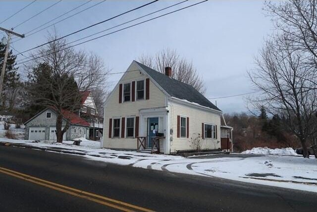 view of front of property featuring an outbuilding and a chimney