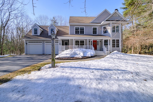 view of front facade with an attached garage, covered porch, and driveway