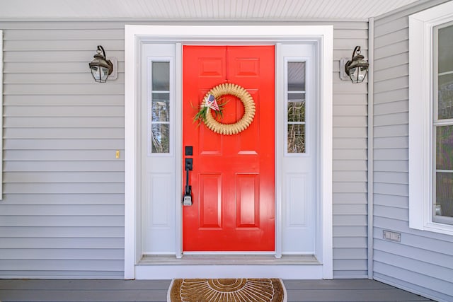 view of exterior entry with a porch