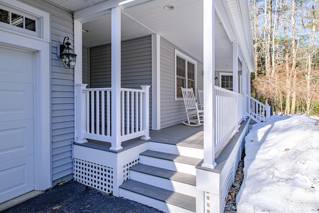 property entrance featuring a porch and an attached garage