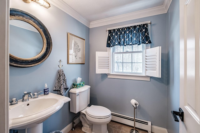 half bathroom with a baseboard radiator, a sink, ornamental molding, tile patterned floors, and toilet