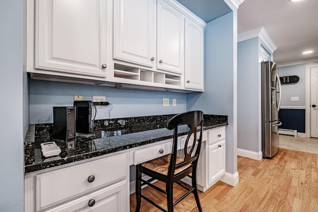 home office featuring ornamental molding, light wood-style flooring, built in desk, a baseboard radiator, and baseboards