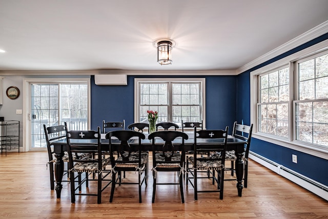 dining space with light wood-style flooring, crown molding, a wall unit AC, and a baseboard radiator