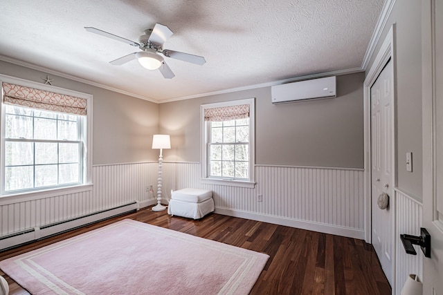 unfurnished bedroom featuring a textured ceiling, an AC wall unit, wood finished floors, and wainscoting