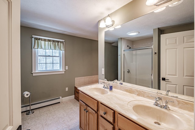 bathroom featuring double vanity, a baseboard radiator, a stall shower, and a sink