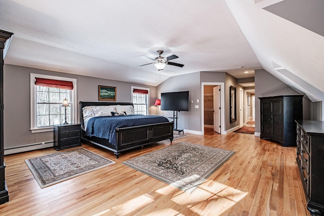 bedroom featuring lofted ceiling, multiple windows, light wood-type flooring, and a baseboard radiator