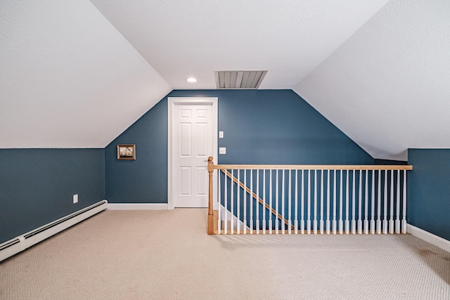 additional living space with lofted ceiling, carpet, baseboards, and a baseboard radiator