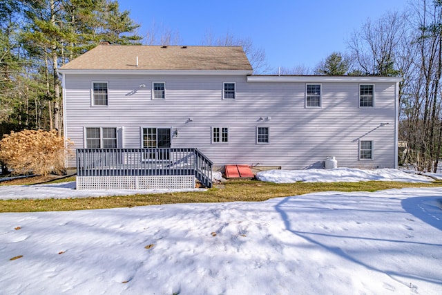 snow covered property featuring a wooden deck