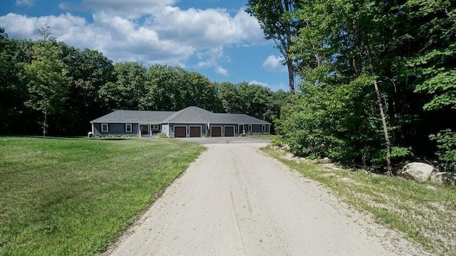 3 Nautical Way, Gray, ME 04039 - single story home with a garage, dirt driveway, a front lawn, and a wooded view
