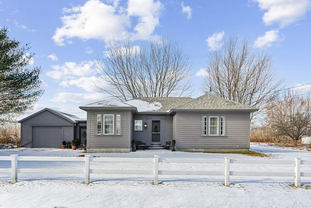 view of front of home with entry steps, a fenced front yard, and roof with shingles