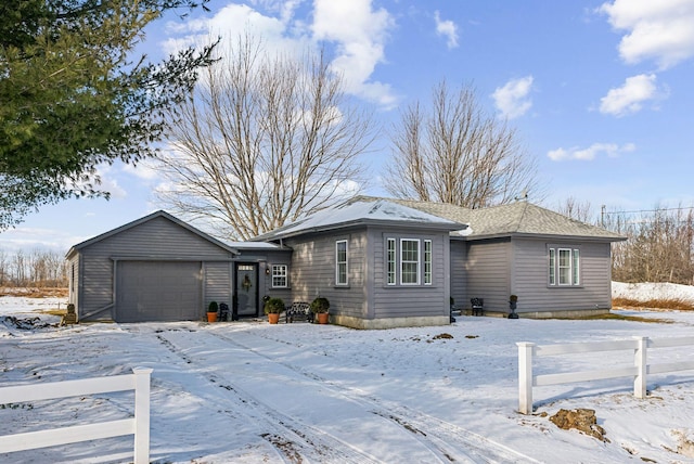 view of front of home with fence, a garage, and roof with shingles