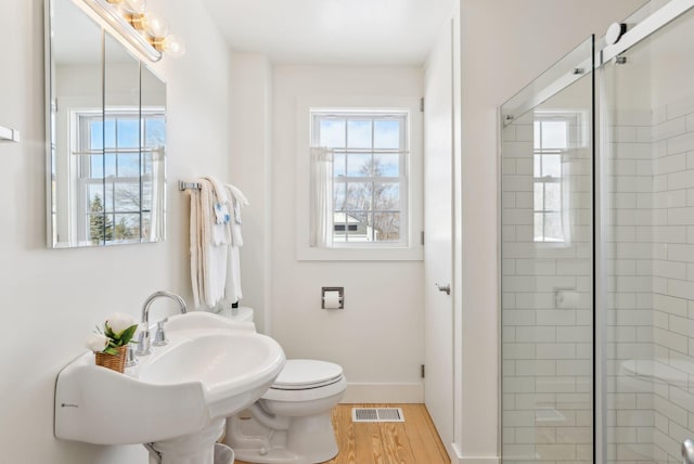 135 P Ridge Rd, Readfield, ME 04355 - full bath with plenty of natural light, a stall shower, toilet, and wood finished floors