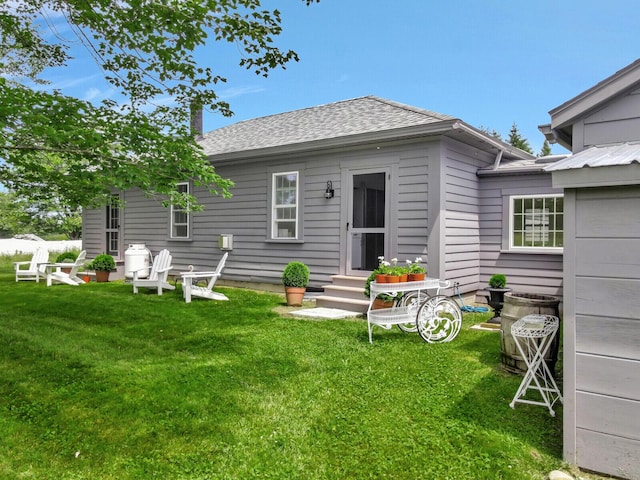 135 P Ridge Rd, Readfield, ME 04355 - back of house with entry steps, a yard, and a shingled roof