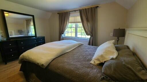 20 Wharf Rd, Blue Hill, ME 04614 - bedroom featuring lofted ceiling, multiple windows, and wood finished floors