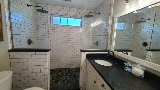 20 Wharf Rd, Blue Hill, ME 04614 - bathroom featuring a walk in shower, vanity, and tile walls