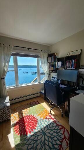 20 Wharf Rd, Blue Hill, ME 04614 - home office with a baseboard heating unit and wood finished floors