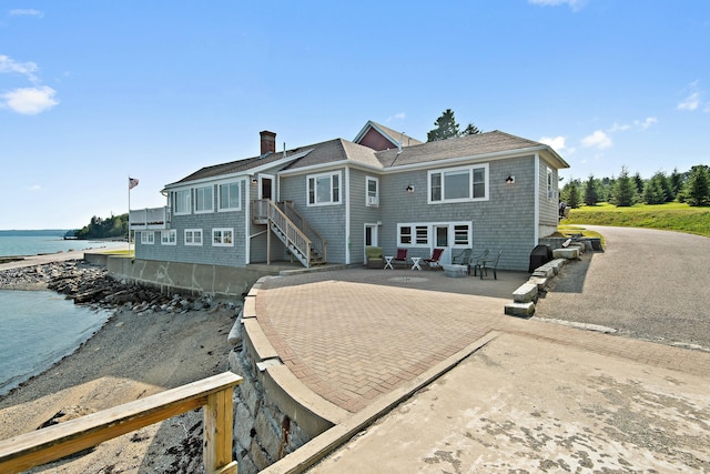 20 Wharf Rd, Blue Hill, ME 04614 - back of house with a water view, a patio, and a chimney