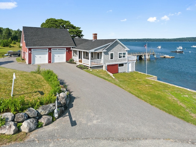 20 Wharf Rd, Blue Hill, ME 04614 - view of front of property with a chimney, a front yard, a garage, a water view, and roof with shingles