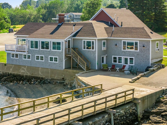 20 Wharf Rd, Blue Hill, ME 04614 - rear view of house with roof with shingles, a chimney, and a patio area