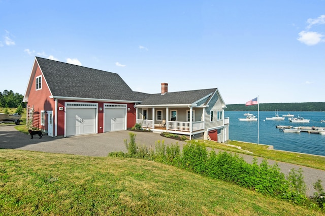 20 Wharf Rd, Blue Hill, ME 04614 - view of front facade with an attached garage, a porch, a chimney, a water view, and roof with shingles