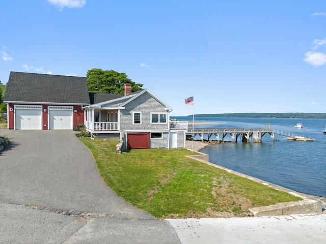 20 Wharf Rd, Blue Hill, ME 04614 - view of front of property featuring a water view, a front yard, a chimney, and asphalt driveway