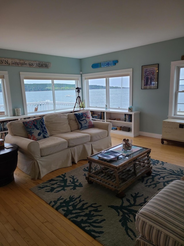 20 Wharf Rd, Blue Hill, ME 04614 - living room featuring wood finished floors, a water view, and baseboards